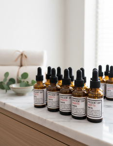 Row of brown bottles with droppers on a white surface, with a neutral background.