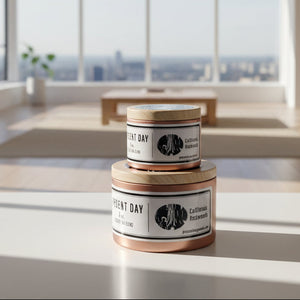 Two 'Agent Day' candles with wooden lids on a white surface.