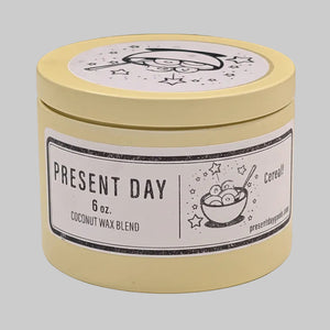 Yellow candle jar with 'Present Day' label on a white background