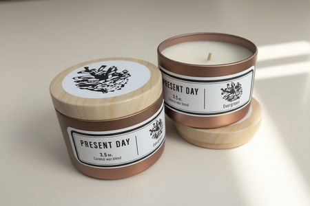 Two candles with 'Present Day' branding on a beige background