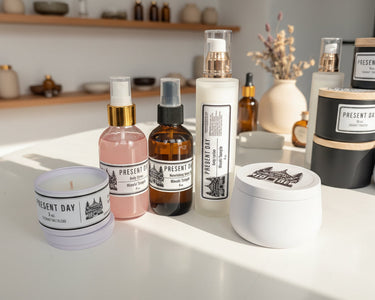 Collection of skincare products including bottles and a candle on a table.