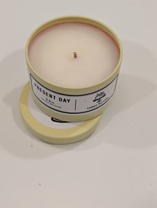 Lemon Tea Cake Candle in a yellow tin with a label on a white counter