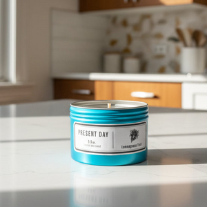 Candle in a blue container on a kitchen counter with a blurred background