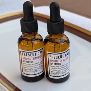 Two amber glass bottles of hair oil 