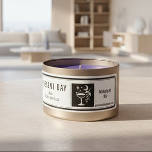 Candle in a 'Present Day' container with a label on a white surface