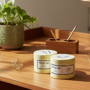 Two 'Present Day' containers on a light surface with a blurred background