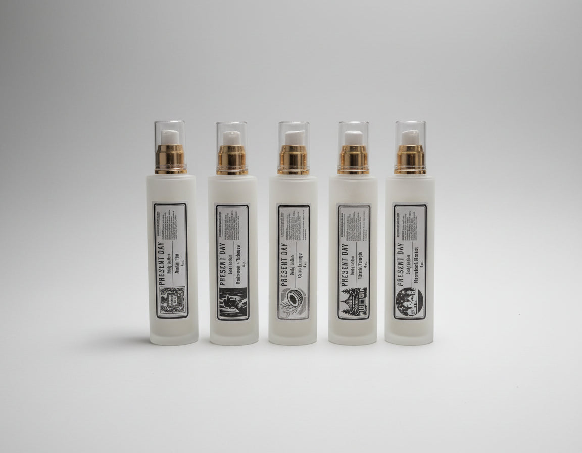 Five white bottles with black labels on a table.