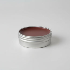 Metal tin with brown substance on a light background