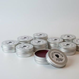 Two tins of lip tint with 'Present Day Goods' labels on a white background
