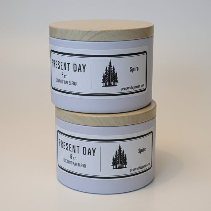 Two cylindrical containers with wooden print tin lids pine scented light background.