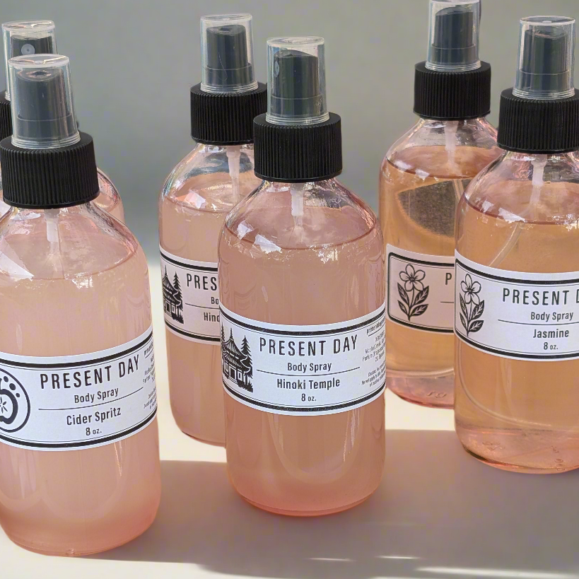 Set of Present Day body spray bottles on a light background