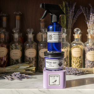 Bottle and jar with 'Present Day' branding on a wooden surface with lavender in the background