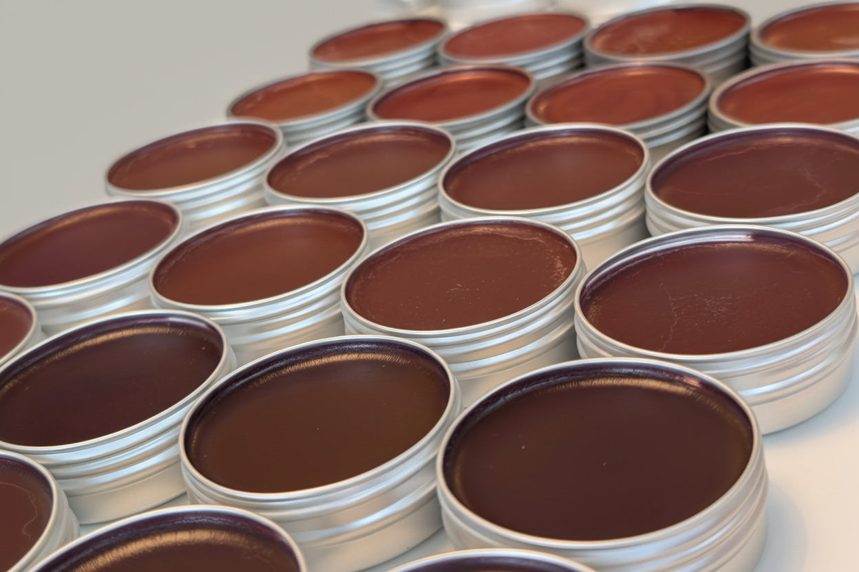 Multiple containers with lip tint tins on a white surface