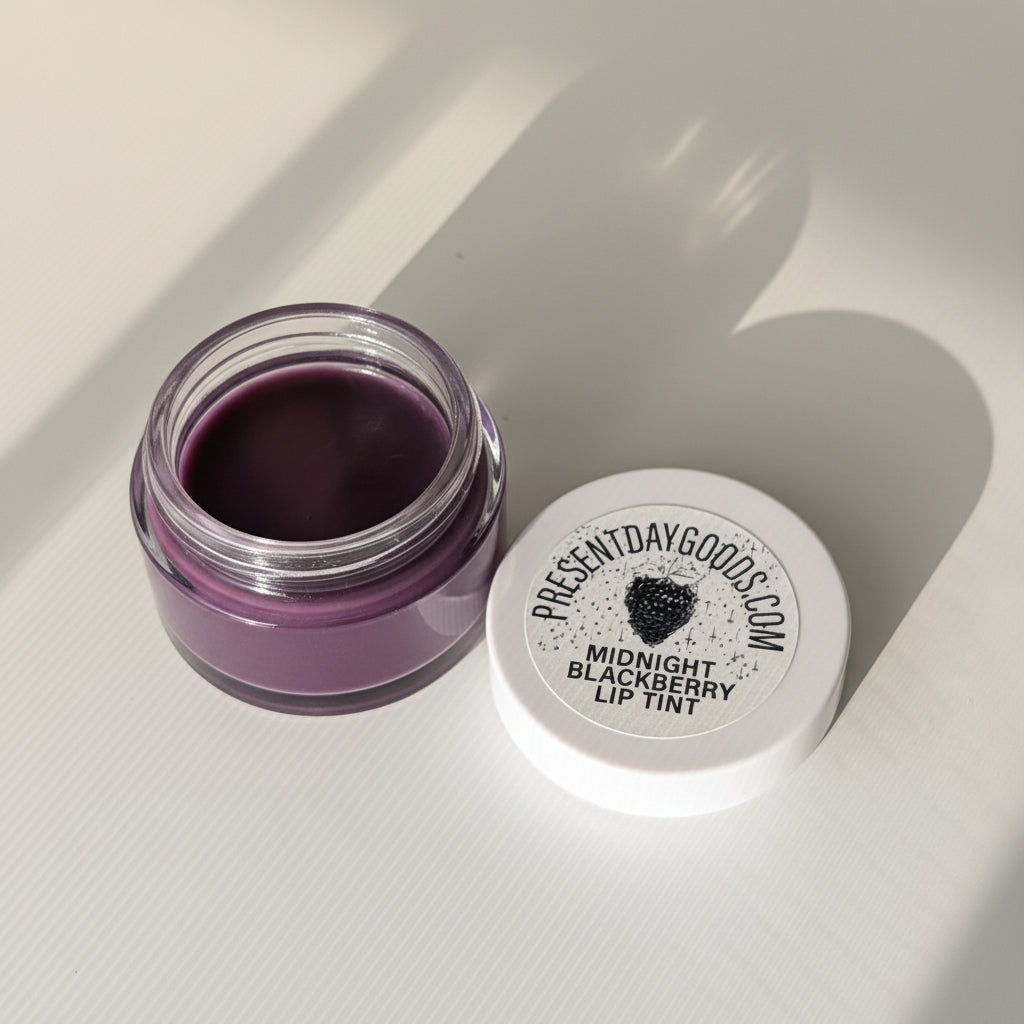 Purple lip tint jar with 'Present Day Goods' label on a white background