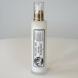 White bottle with gold cap on a white surface