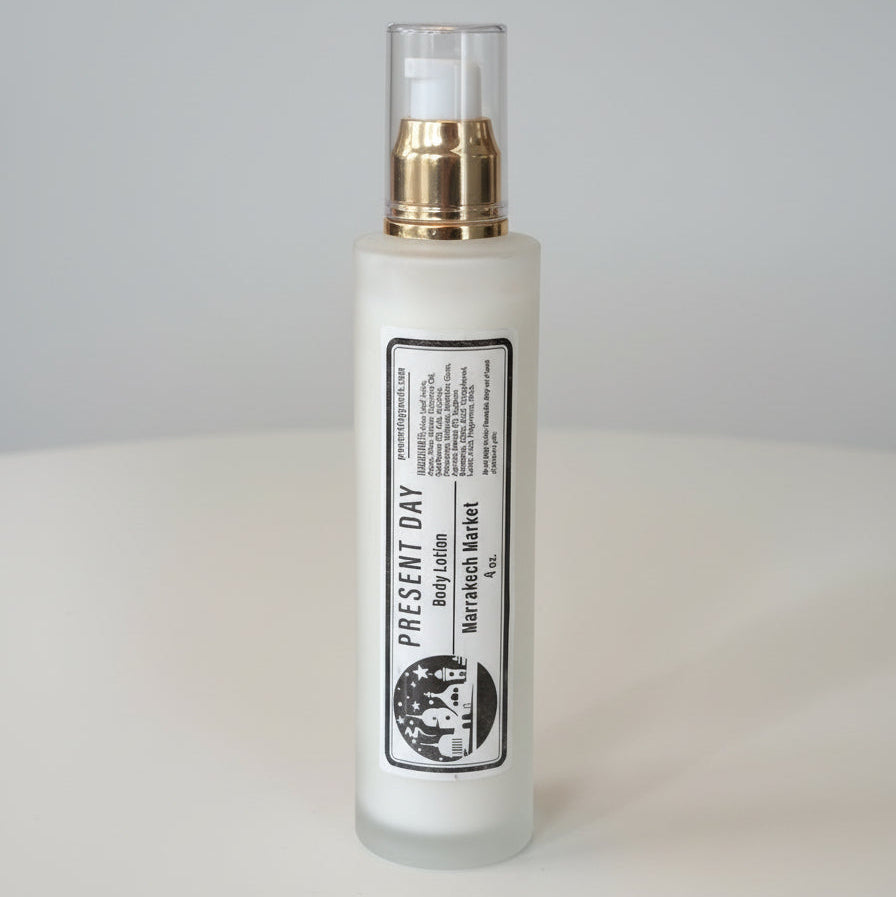 White bottle with gold cap on a white surface