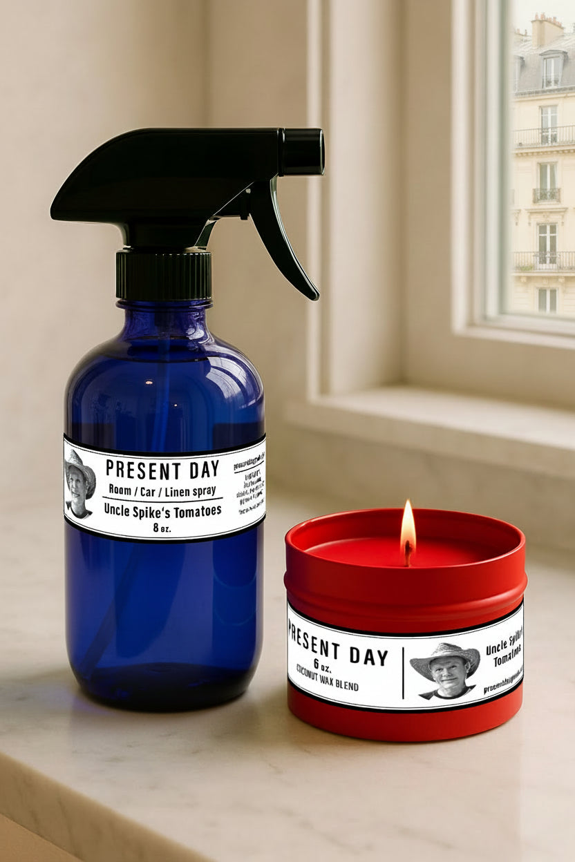 Blue spray bottle and red candle with 'Present Day' labels on a surface.